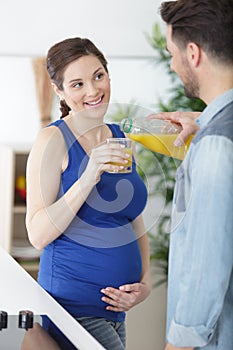 Man and woman having juice indoors