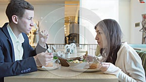 Man and woman having lunch at a cafe. Business lunch