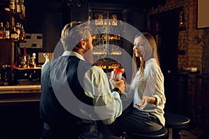 Man and woman having nice conversation at bar counter