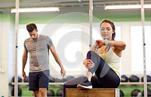 Man and woman with heart rate tracker in gym