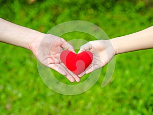 Man and woman heart shape hands hold the red heart. Couple, Love, Valentine`sDay Concept