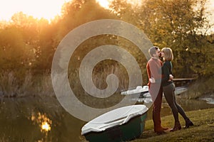 Man and woman heterosexual couple hug each other in autumn yellow forest