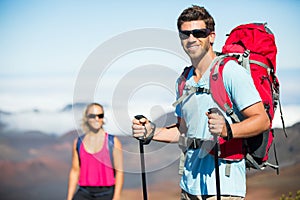 Man and woman hiking on beautiful mountain trail