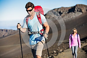 Man and woman hiking on beautiful mountain trail