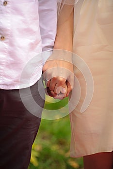 Man and woman hold hand standing near each other