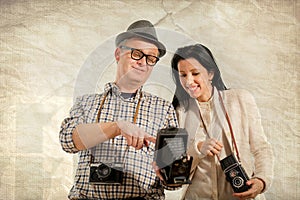 Man and woman hold retro camera. Texture background