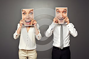 Man and woman holding amazed happy faces