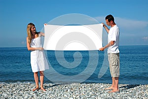 Man and woman holding billboard