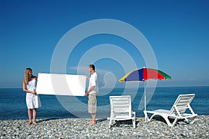 Man and woman holding blank placard