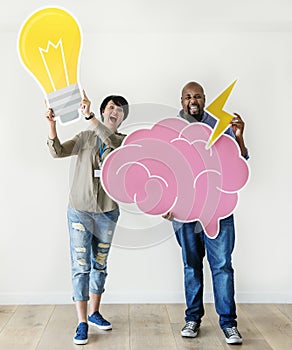 Man and woman holding bulb and pink cloud icons respectively