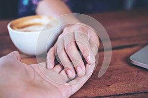 A man and a woman holding each other hands with feeling love