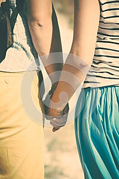 Man and woman holding hands.