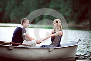 Man and woman holding hands in boat