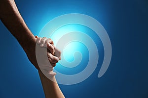 Man and woman holding hands on color background, closeup.