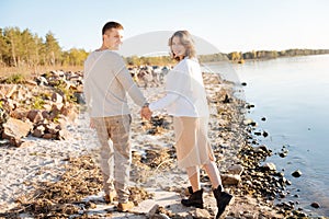 Man and a woman holding hands while walking together