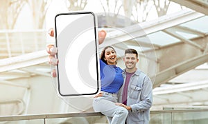 Man and Woman Holding up a Cell Phone