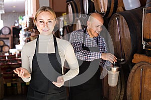 man and woman holding wine vessels