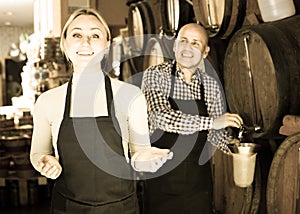 Man and woman holding wine vessels