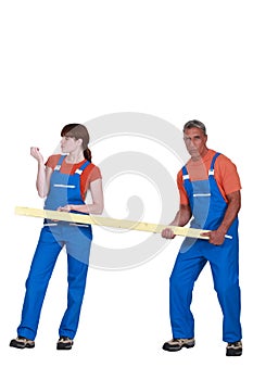 Man and woman holding wood