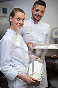 man and woman ice cream maker working in factory