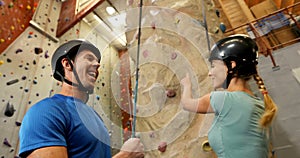 Man and woman interacting with each other during bouldering 4k