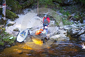 Man and woman on the kayak. A man and a woman on the bank of the river are resting pouring water from boats, carrying kayak to