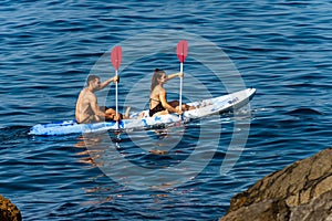 Man and woman kayak in the blue sea - Liguria Italy