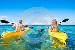 Man and Woman Kayaking in the Ocean photo