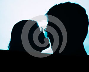 Man and woman kissing projector shadows