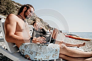 Man woman laptop sea. Working remotely on seashore. Happy successful couple, freelancers working on sea beach, relieves