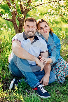 a man and a woman on a lawn in the park. romantic picnic