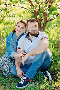 a man and a woman on a lawn in the park. romantic picnic