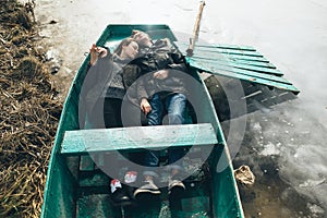 Man and woman lie in the boat