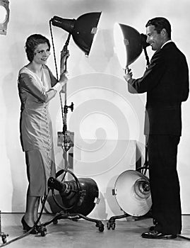 Man and woman with lights on stands