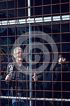 Man and woman locked in a cage at an abandoned building