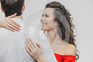 Man and woman with long hair. The wife hugged her husband. Back view. Valentine`s Day. I Woman dressed in red man dress