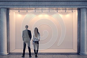 Man and woman looking at storefront