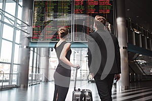 Man and woman looking at the timetable in the airport