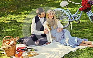 Man and woman in love. Couple in love enjoy picnic time. Spring date. Playful couple having picnic in park. Romantic