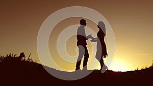 Man and Woman love silhouette in sunset slow motion video. Couple in love kissing at sunrise family silhouette. married