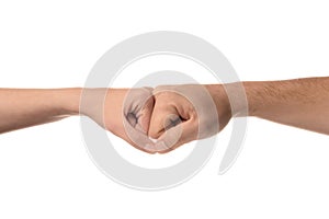 Man and woman making fist bump gesture on white background