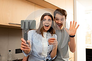 Man and woman making selfie by mobile phone at home