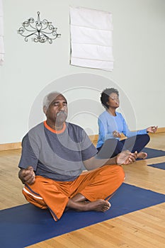 Man And Woman Meditating In Lotus Position