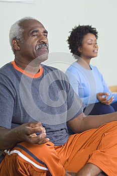 Man And Woman Meditating In Lotus Position