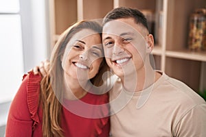 Man and woman mother and son hugging each other sitting on desk at home