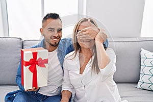 Man and woman mother and son surprise with giff at home photo