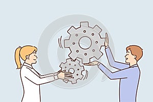 Man and woman move gears togethersymbolizing industrial business process