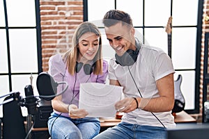 Man and woman musicians singing song at music studio