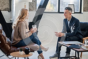 A man and a woman in the office having a conversation