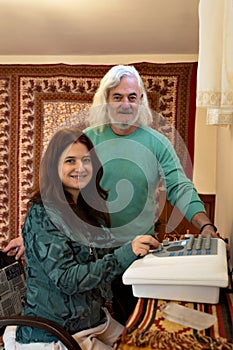 Man and woman in an office performing a diagnosis with a radionic machine. Alternative medicine treatment